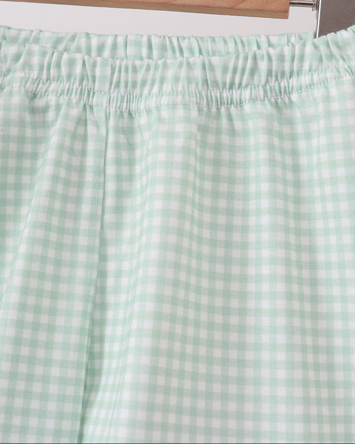 Light sage gingham shorts with elastic waistband and gathered ruffle hem