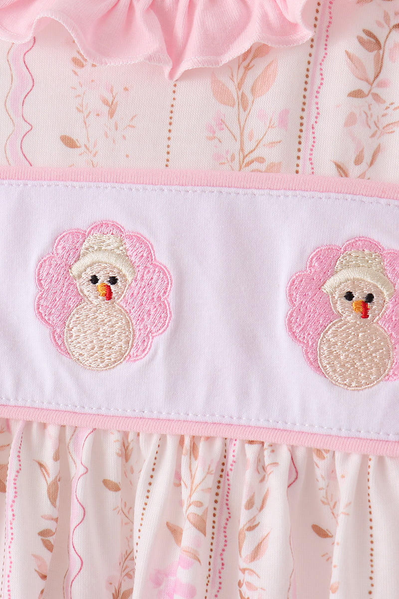 Embroidered turkey faces on the pink bloomer waistband with ruffle trim