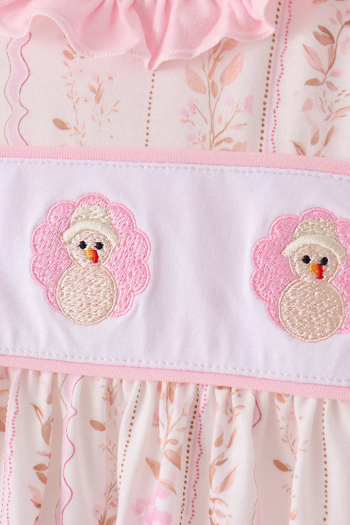 Embroidered turkey faces on the pink bloomer waistband with ruffle trim