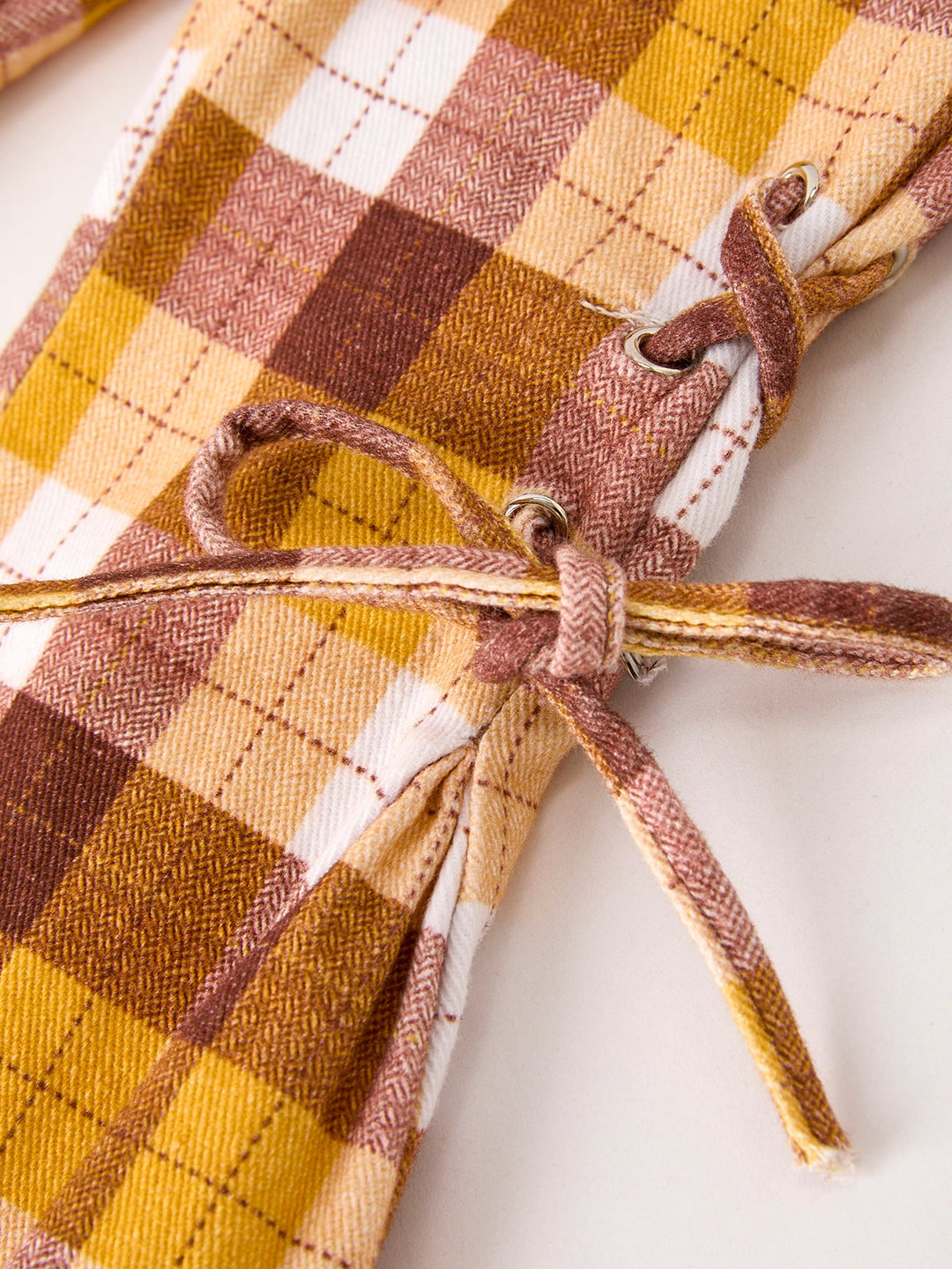 Plaid trousers with side bow-tie drawcord detail and stitched hem