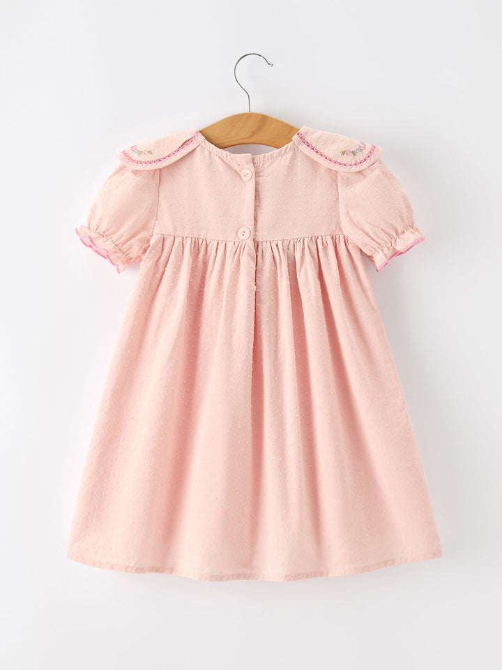 Pink baby dress with puff sleeves, button front, and embroidered round collar