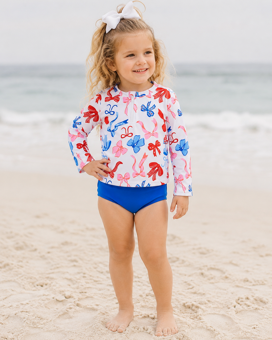 Young girl on beach wearing 4th of July Boutique Swimsuit