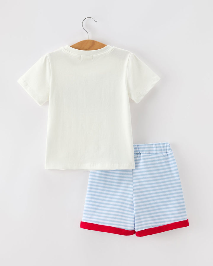 White t-shirt and blue striped shorts on a hanger against a white background