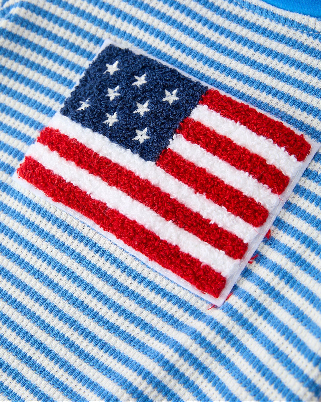 American flag patch on a blue and white striped fabric