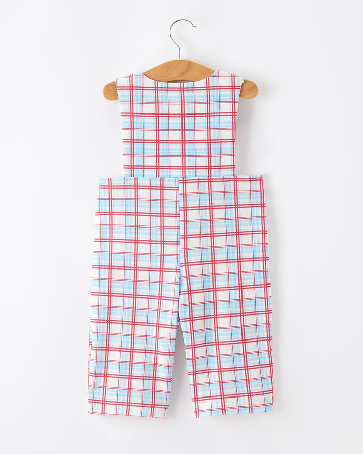 Plaid jumpsuit on a hanger against a white background