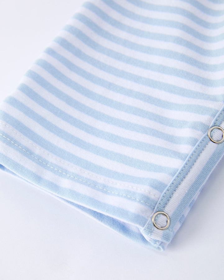 Blue and white striped fabric with grommets on a white background