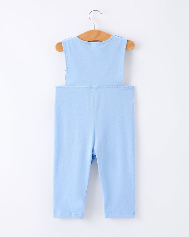 Light blue denim jumpsuit on a wooden hanger against a white background