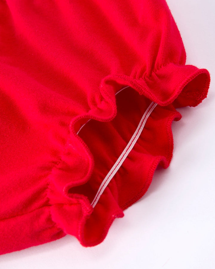 Close-up of a red fabric with ruffled edge on a white background