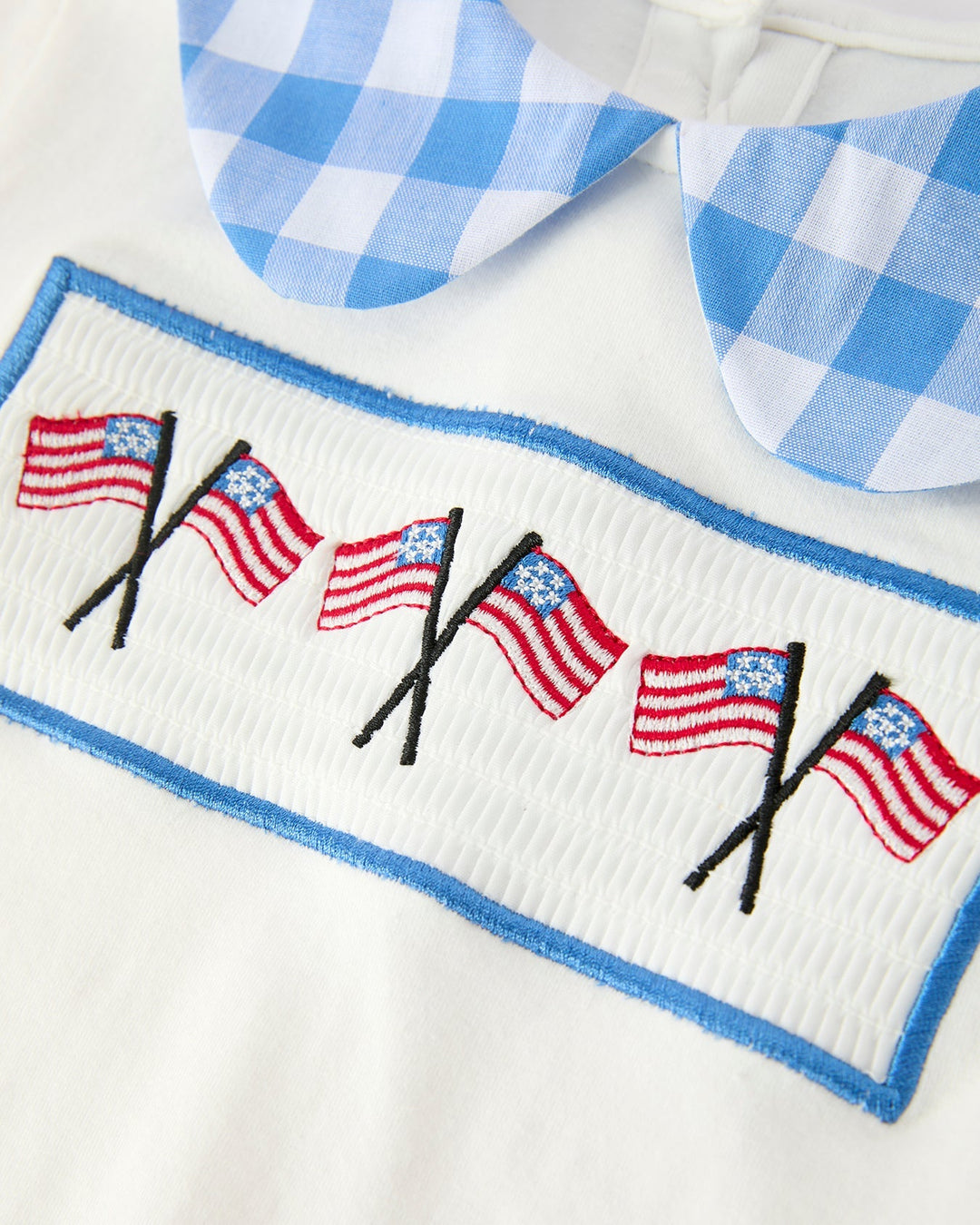 Embroidered top with American flag design on a white background