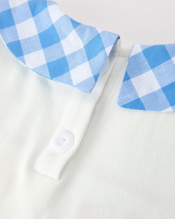 White shirt with blue and white checkered collar and cuffs on a light gray background