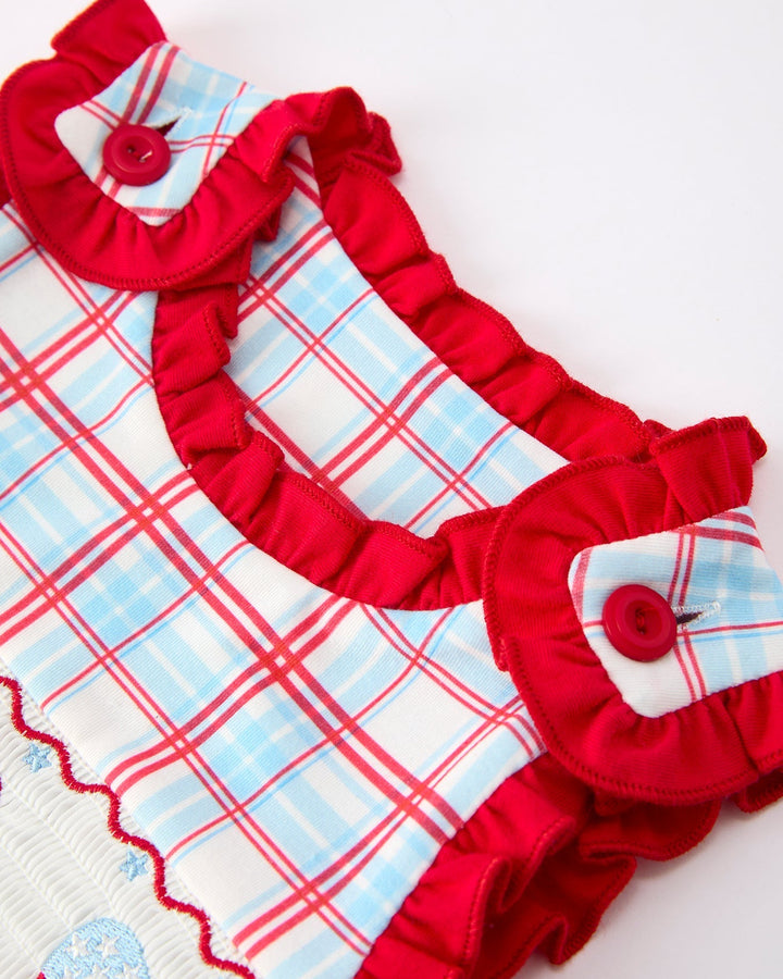Red and blue plaid dress with ruffles on a white background