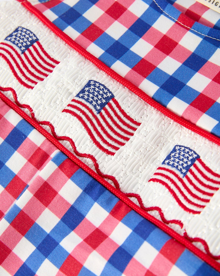 Fabric with American flag pattern and checkered design in red, white, and blue.