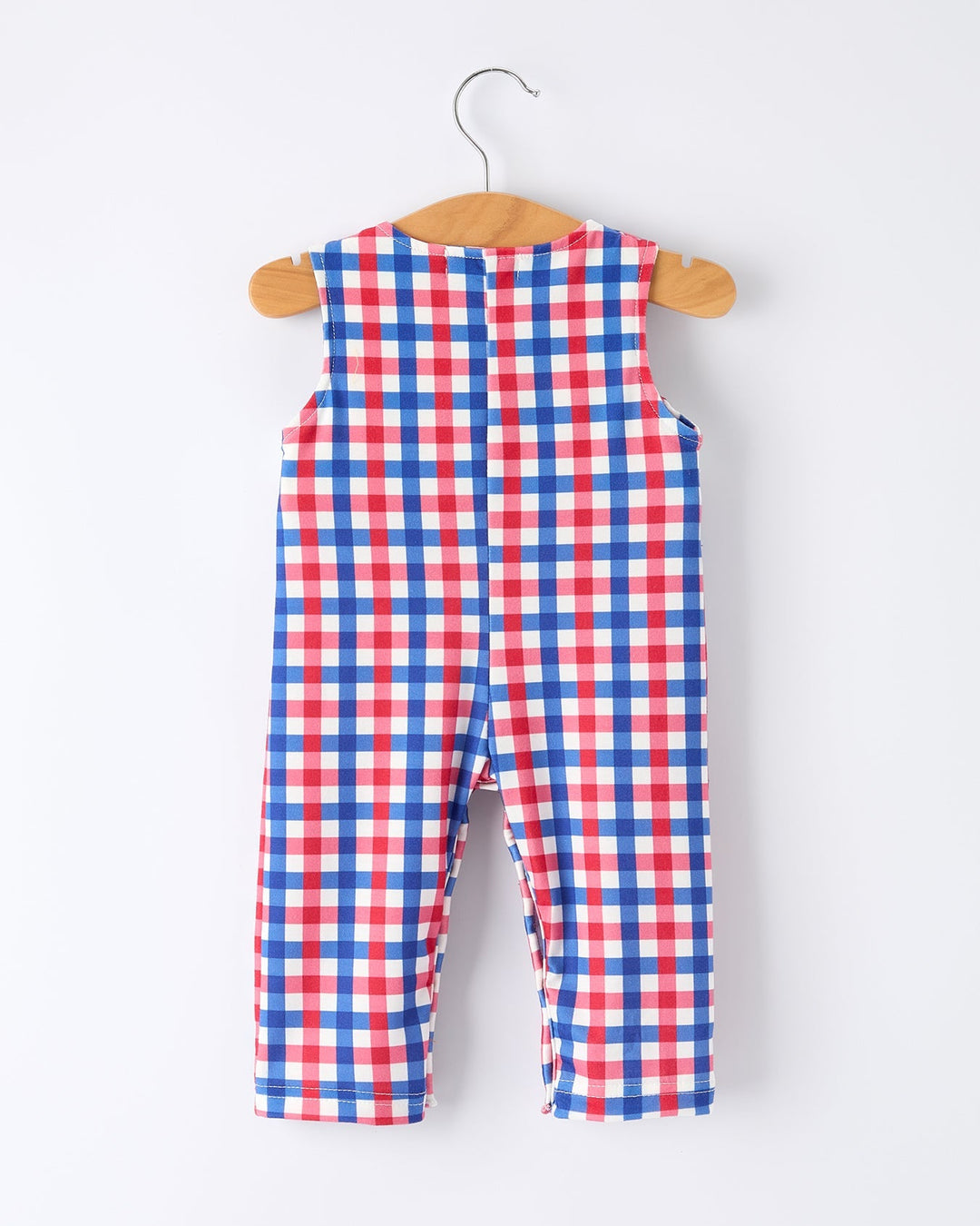 Red, white, and blue checkered romper on a hanger against a white background