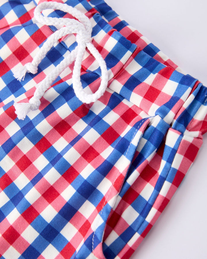 Red, white, and blue checkered shorts with a drawstring on a white background