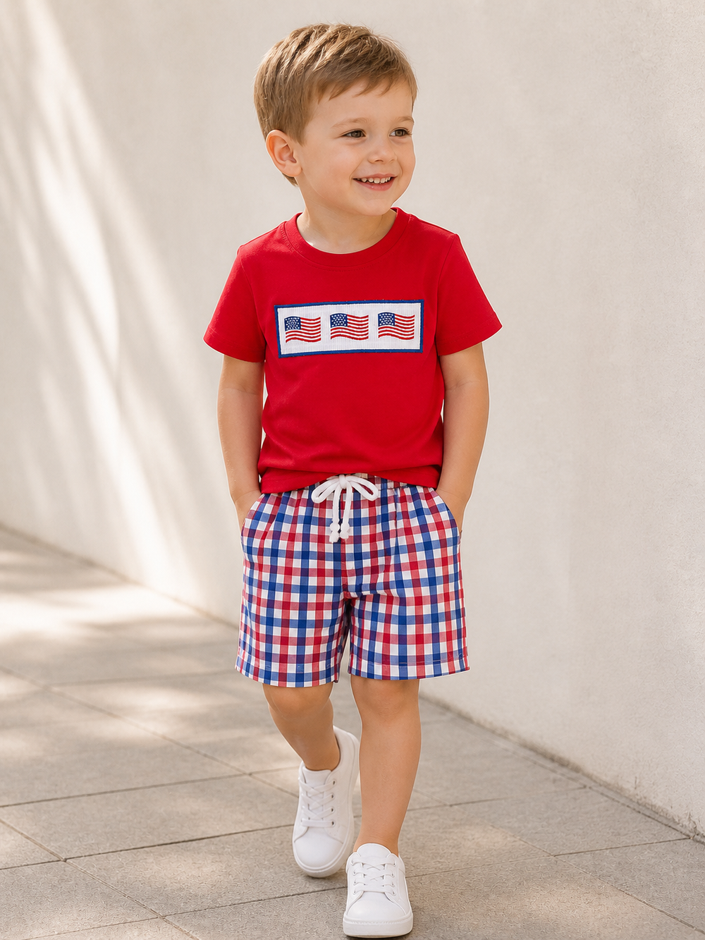 Young boy in flag embroidered fourth of july outfit