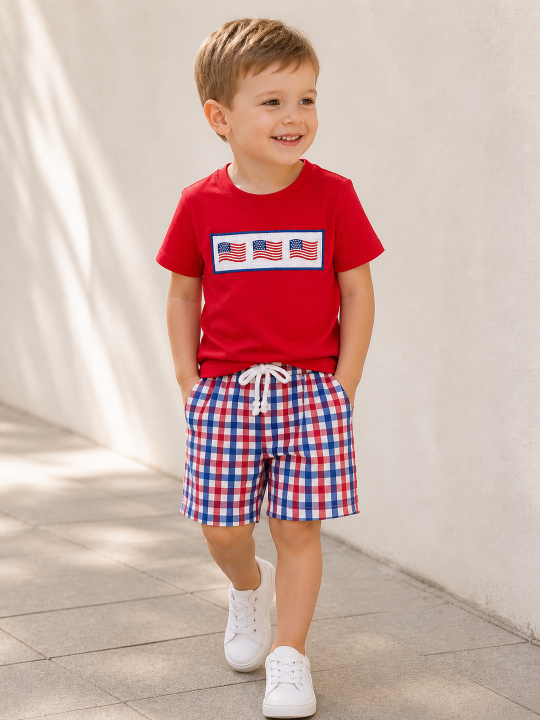 Young boy in flag embroidered fourth of july outfit