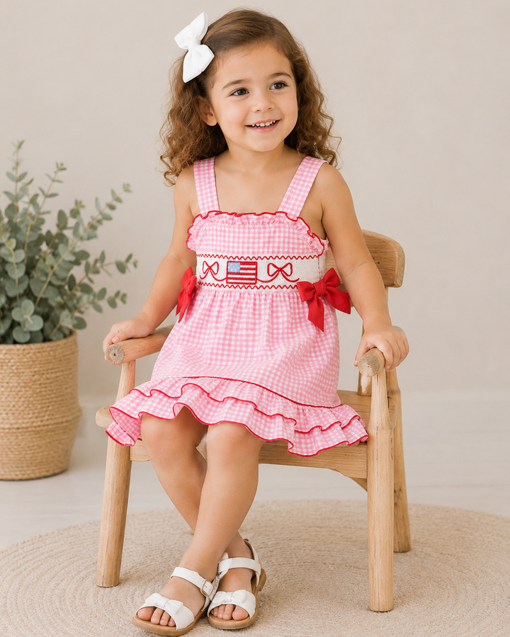 Young girl sitting on chair wearing 4th of July Plaid Ruffle Dress