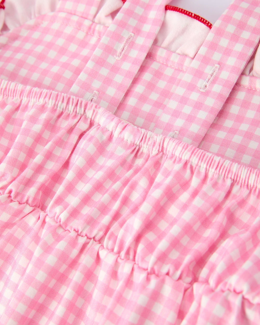 Close-up of a pink and white checkered fabric with ruffled edges.