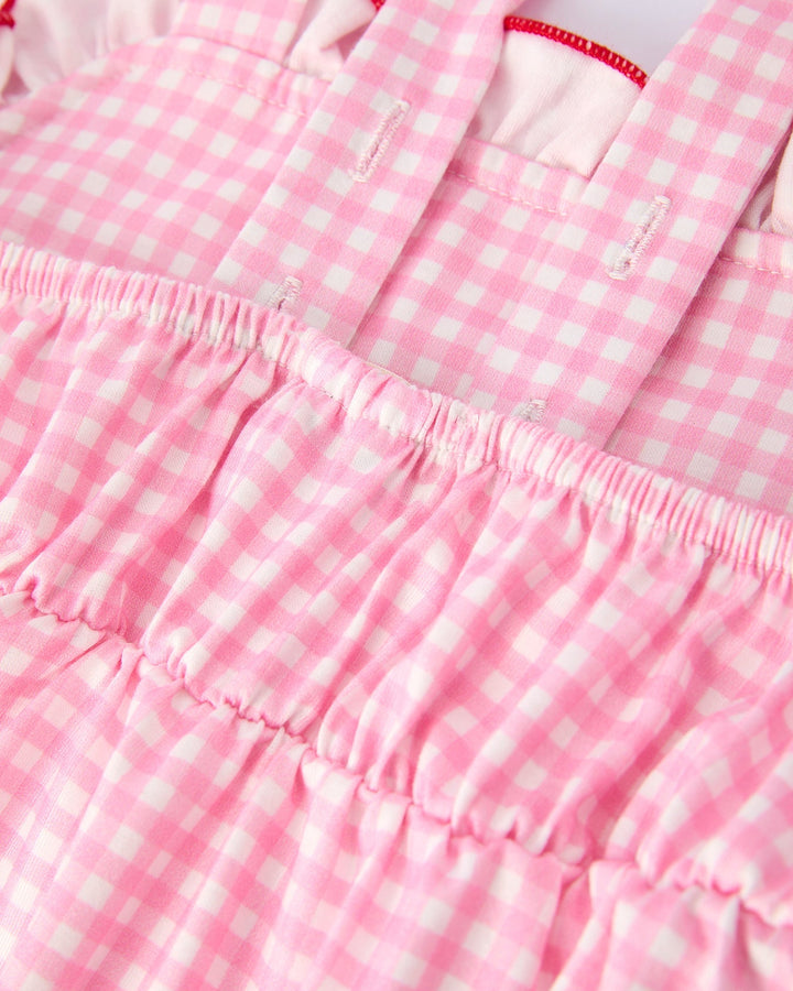 Close-up of a pink and white checkered fabric with ruffled edges.