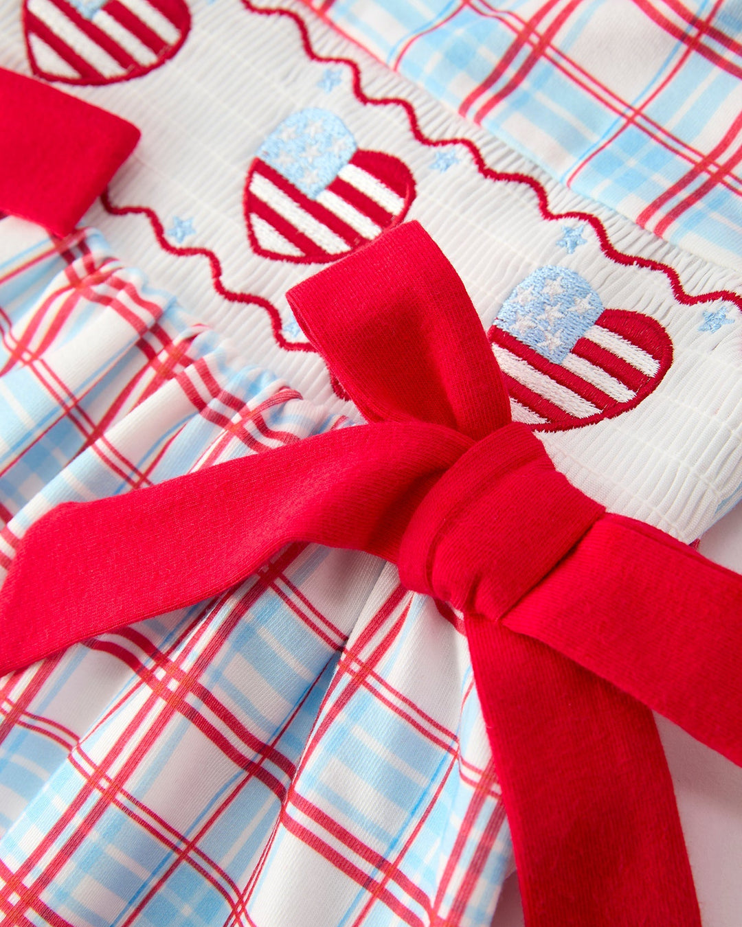 Plaid fabric with a large red bow in the center