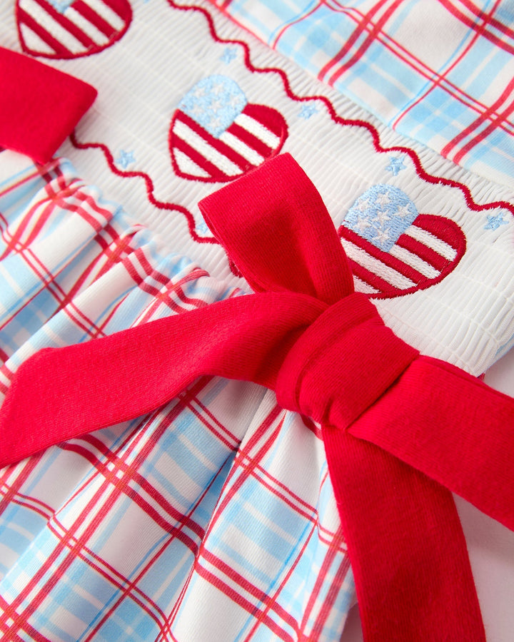 Plaid fabric with a large red bow in the center