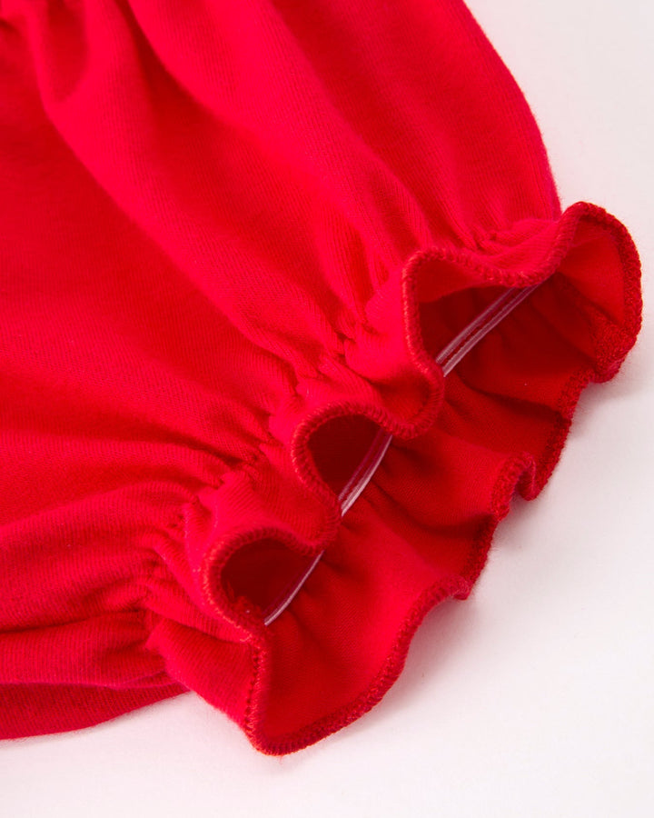 Close-up of a red fabric with a bow on a white background