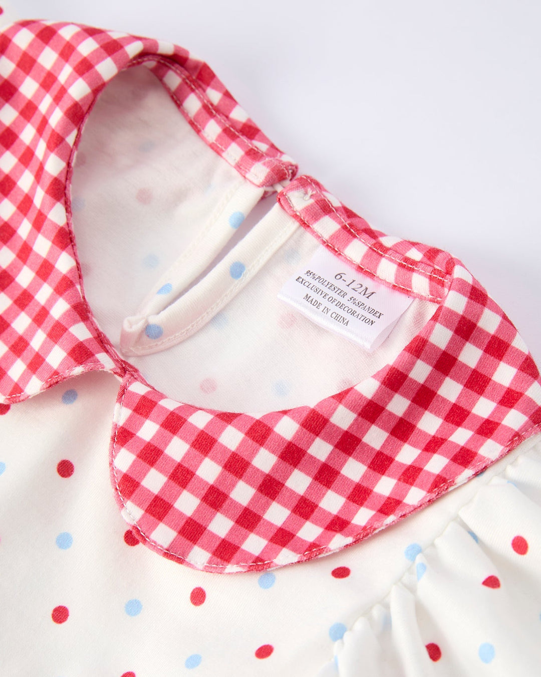Red and white checkered bib with a label on a white background