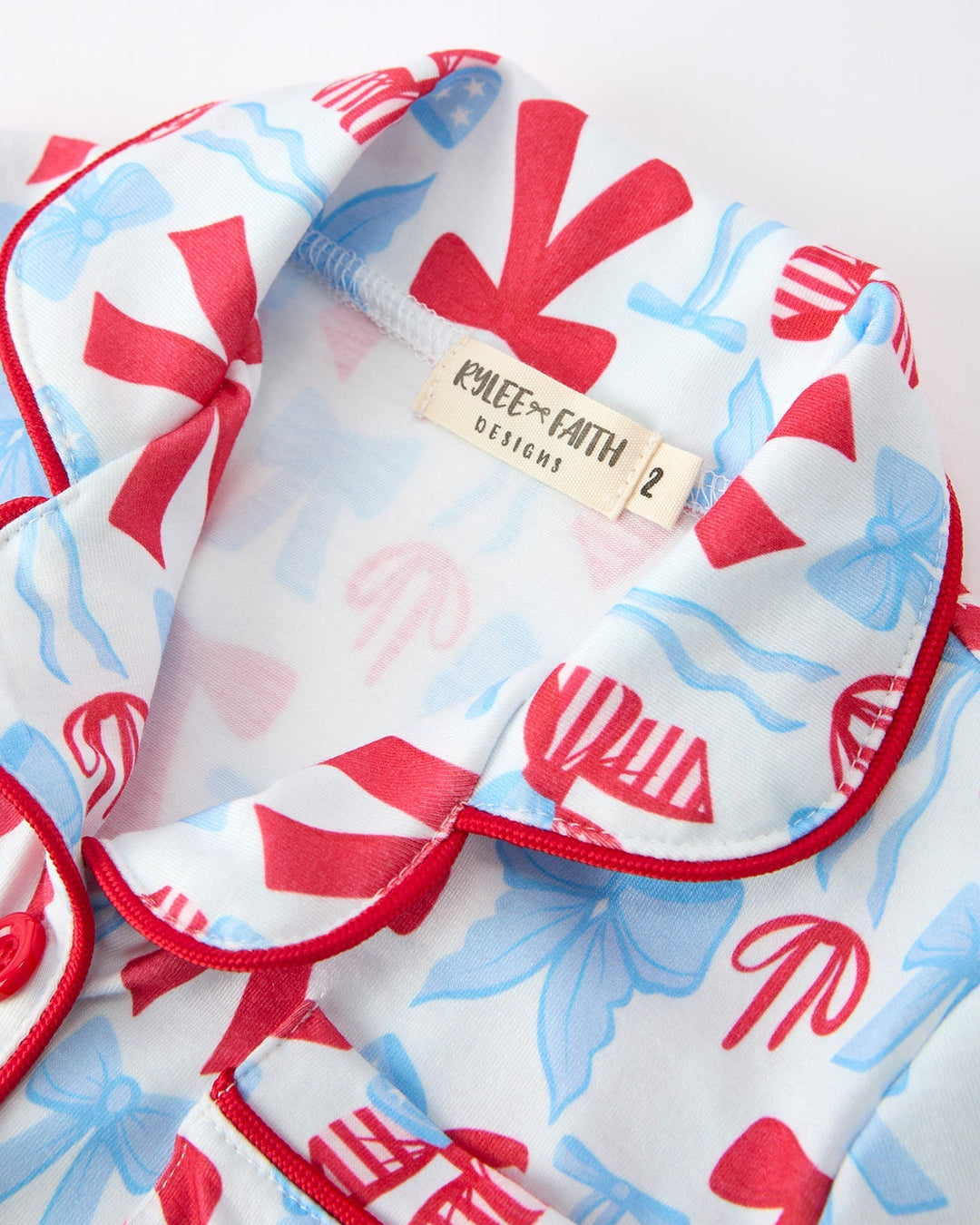 Girls pajamas with red and blue patterns on a white background