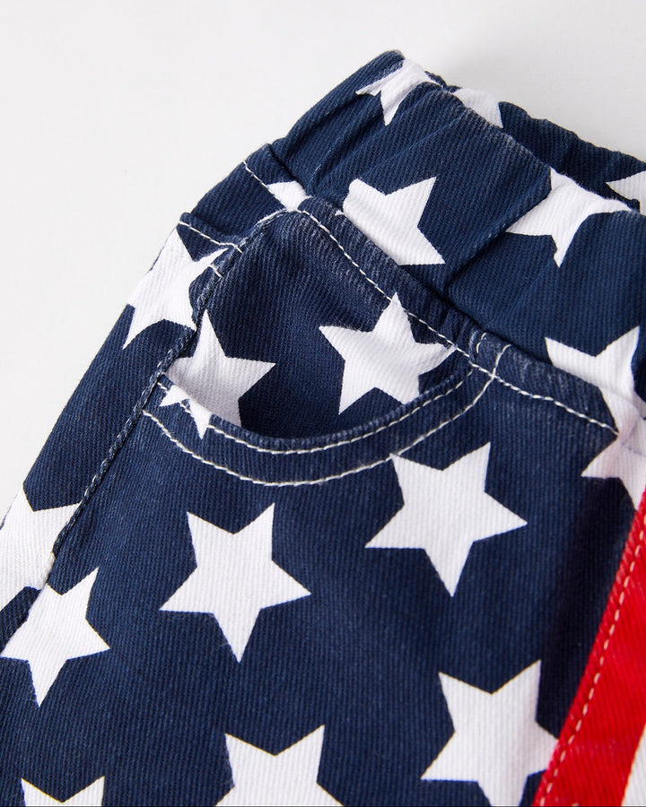 Close-up of a navy blue fabric with white star pattern on a plain background