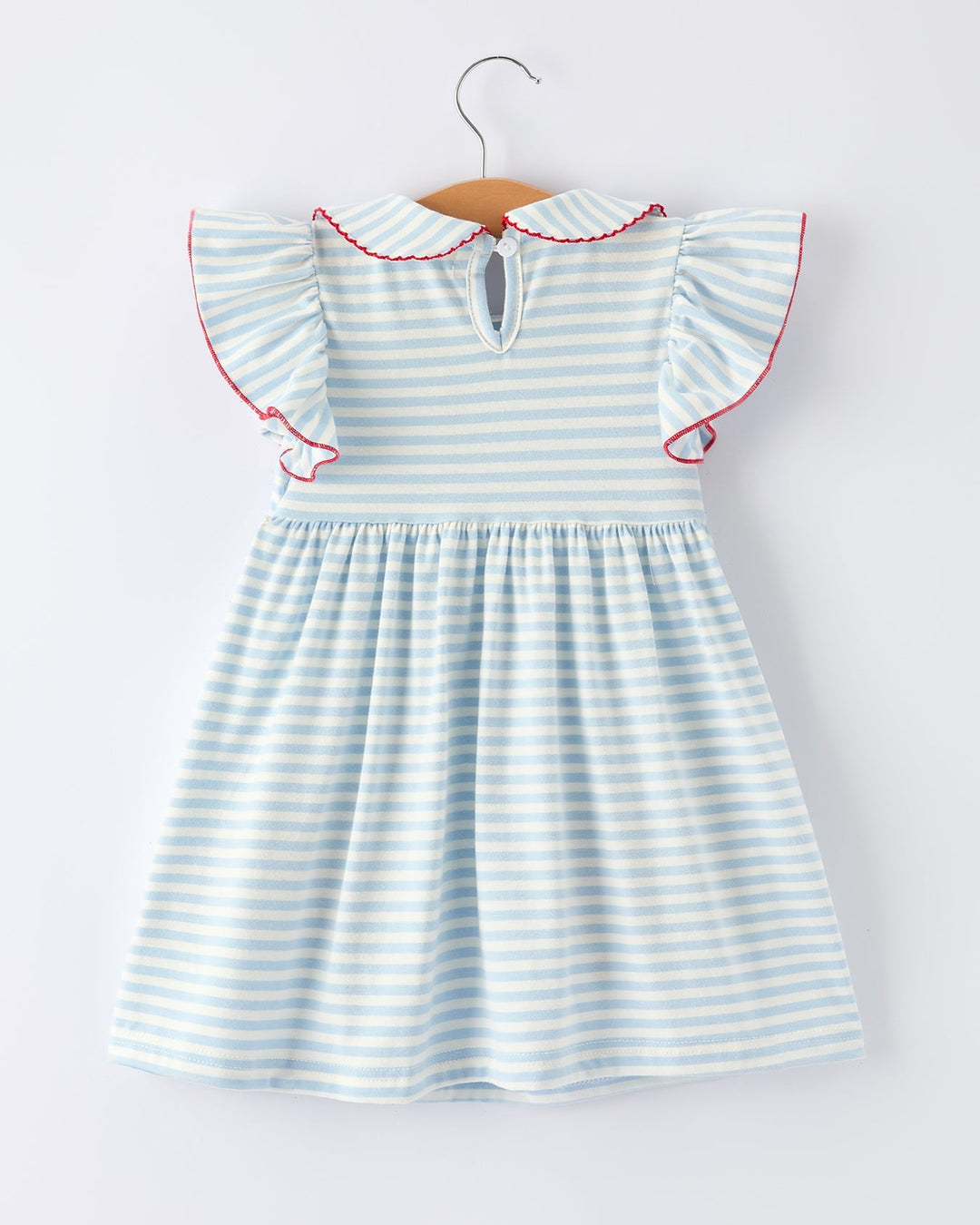 Striped dress with ruffled sleeves on a hanger against a white background