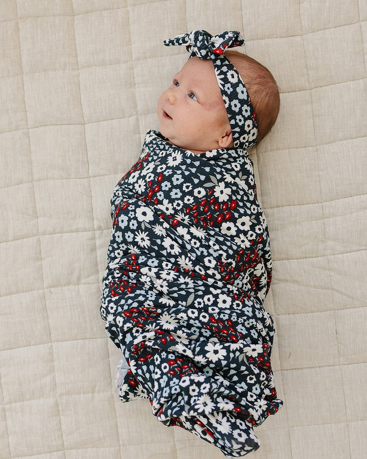 Navy floral ribbed head wrap with tied bow on infant, side profile