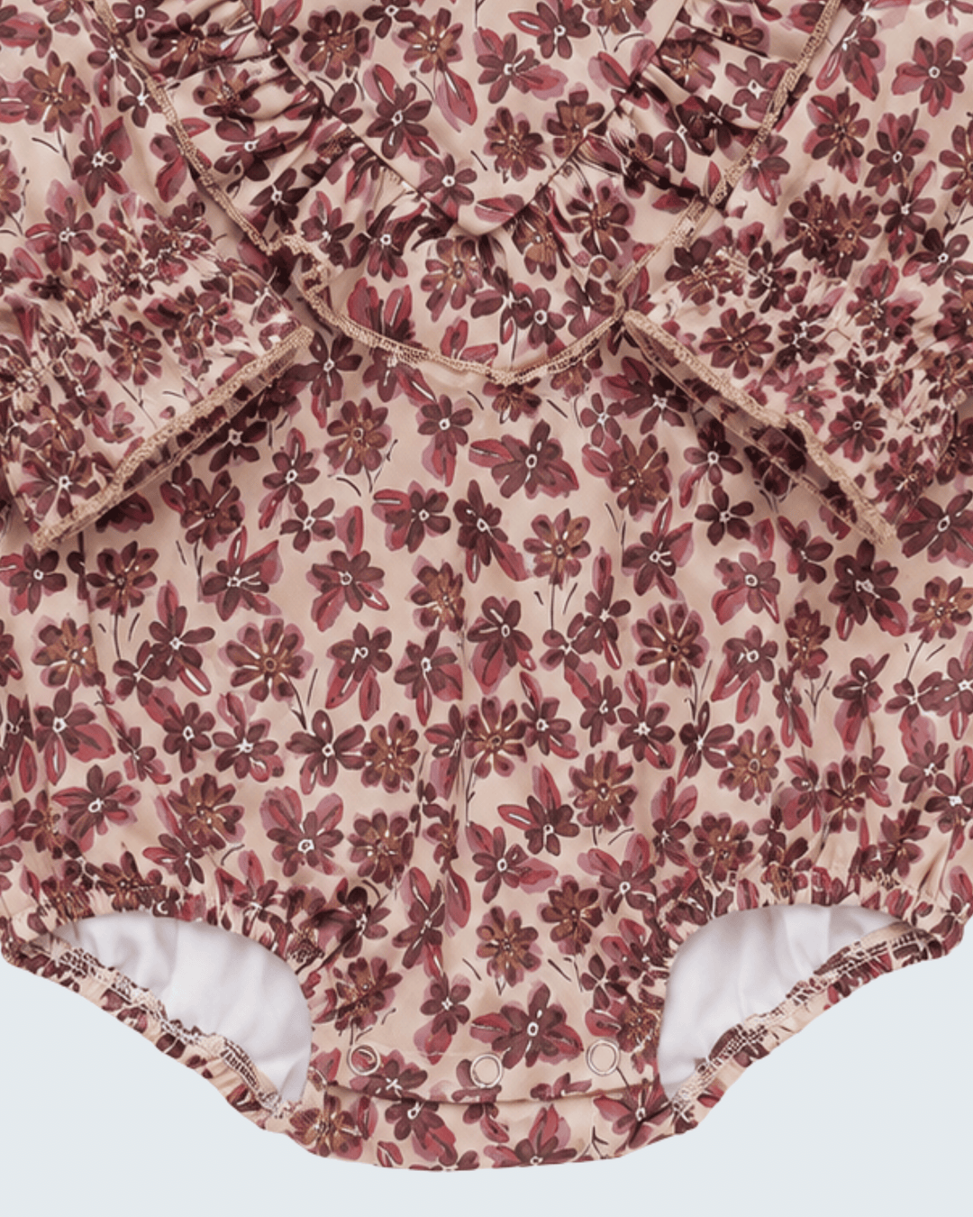 Pink floral bubble romper with gathered ruffle trim and elastic leg openings