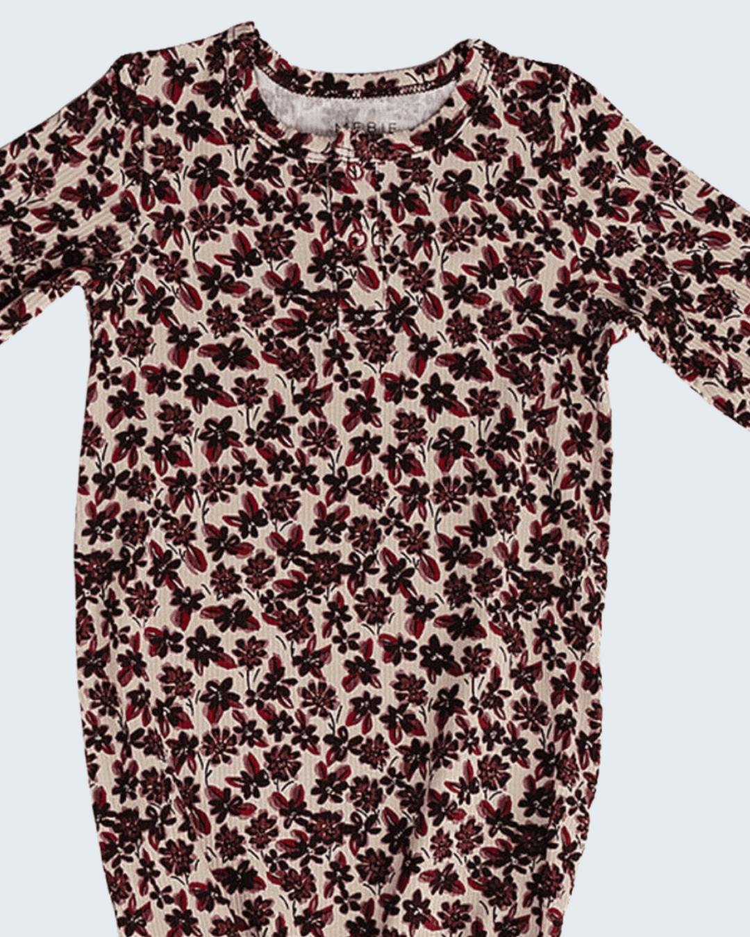 A long-sleeve baby romper with an all-over floral print in dark red and black on a light beige background, shown against a solid light gray background.
