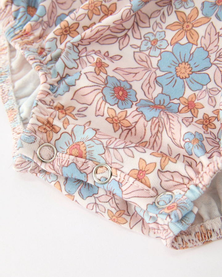Floral baby romper with elastic cuffs and crotch snaps