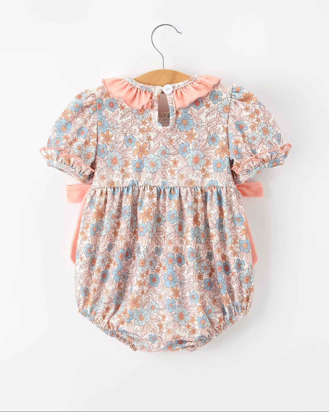 Floral baby romper with pink ruffled collar, button back, gathered smocked waist