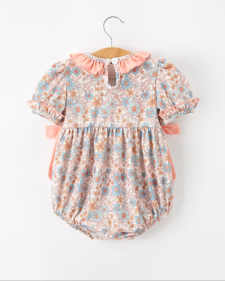 Floral baby romper with pink ruffled collar, button back, gathered smocked waist