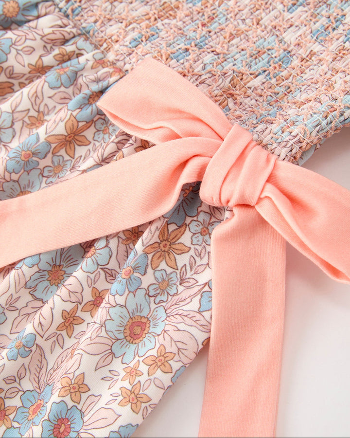 Girls floral dress with pink ribbon bow at the waist and gathered fabric