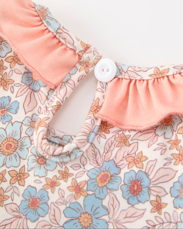 Girls floral dress back with small white button, pink elastic neckline and ruffled trim