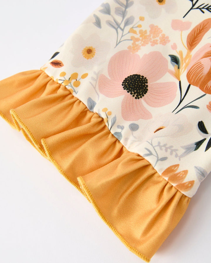 Cream floral pajama sleeve with orange ruffled cuff and gathered trim detail