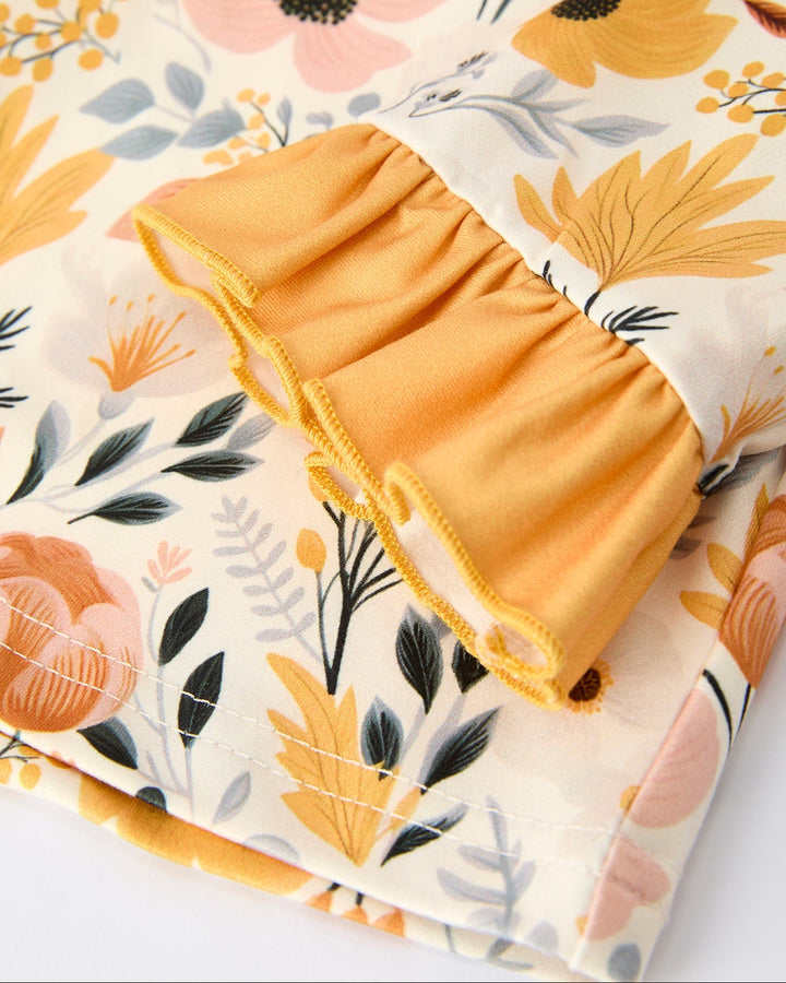 Cream floral pajama top with orange ruffle hem and sleeve trim detail