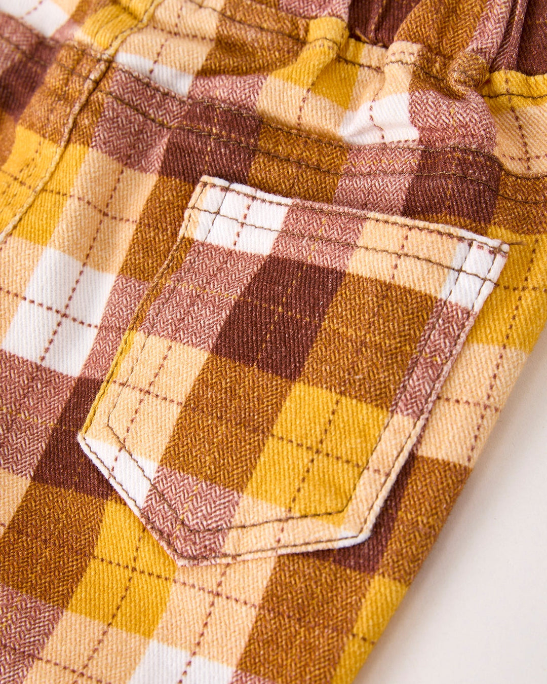 Plaid trousers with front patch pocket and topstitched plaid lining
