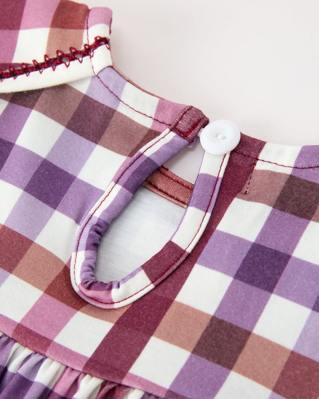 Girls plaid dress back yoke with small button closure and ruffled hem