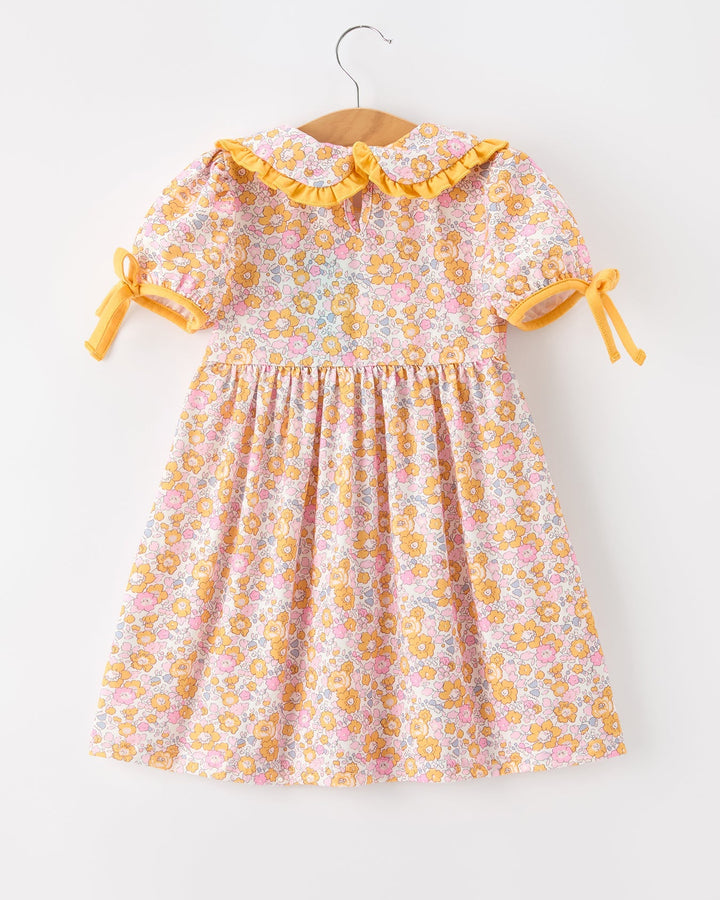 Girls floral dress with orange trim, gathered skirt and side bow tie sleeves
