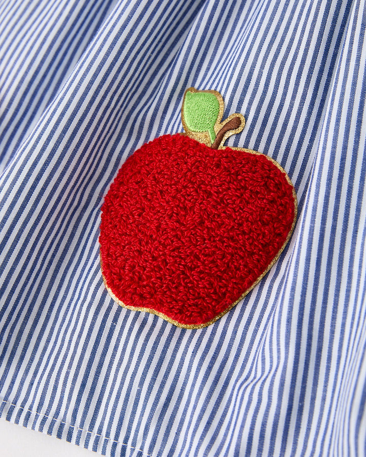 Red apple patch on a blue and white striped shirt