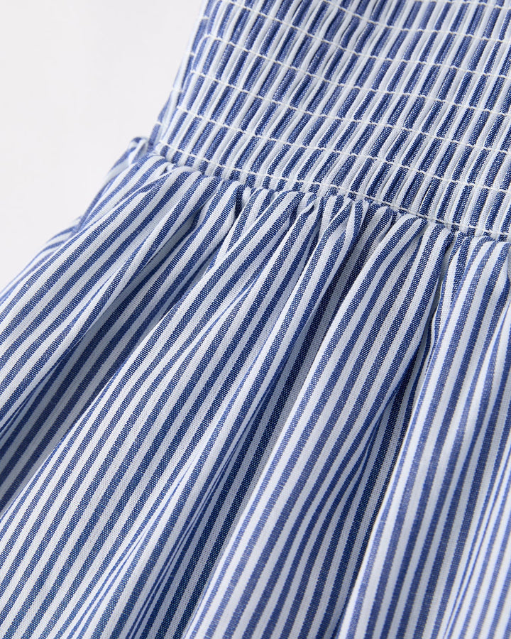 Close-up of a blue and white striped dress with a plain background