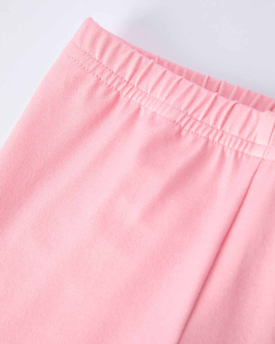 Close-up of pink pants on a light gray background