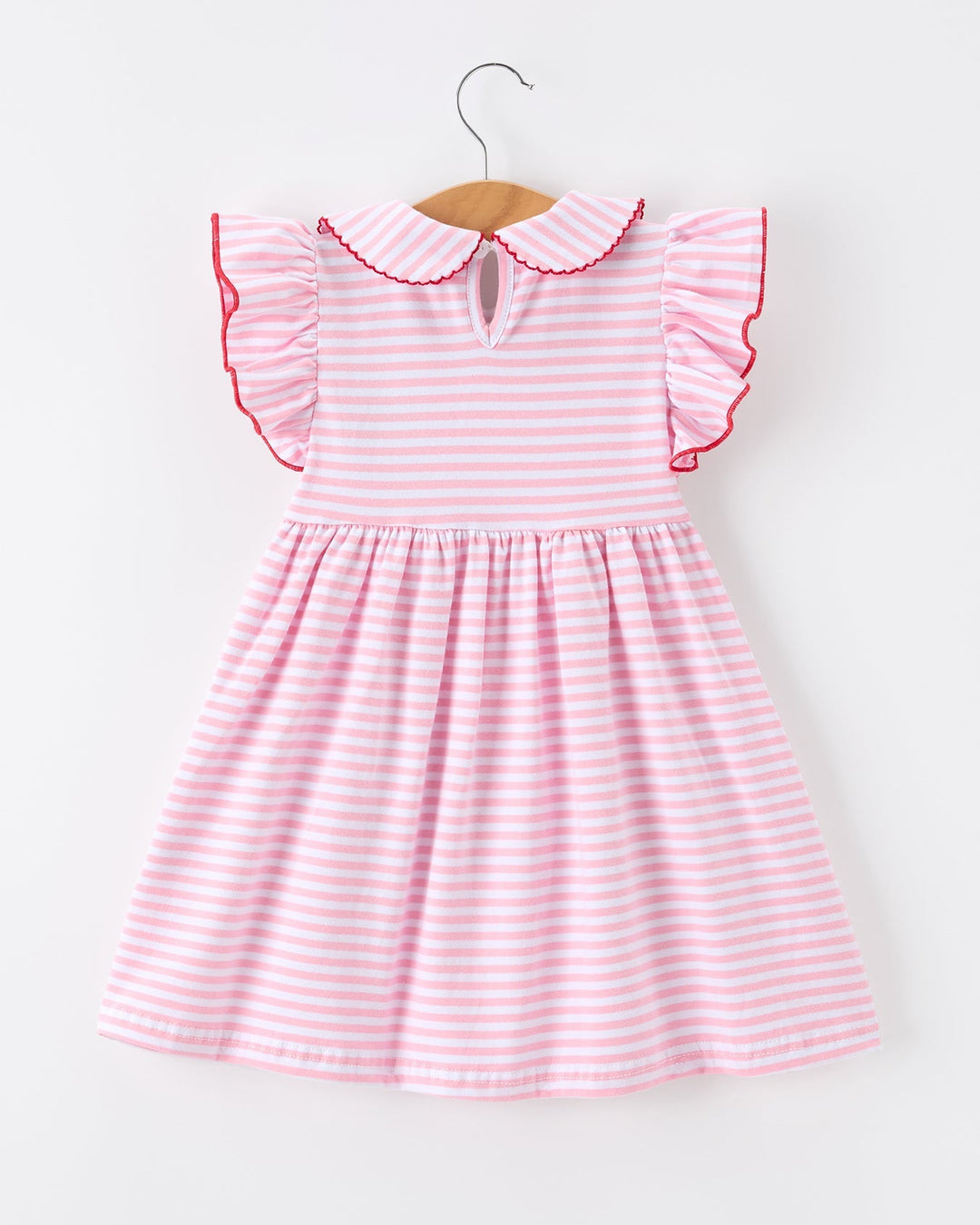 Pink and white striped dress with ruffled collar on a hanger against a white background