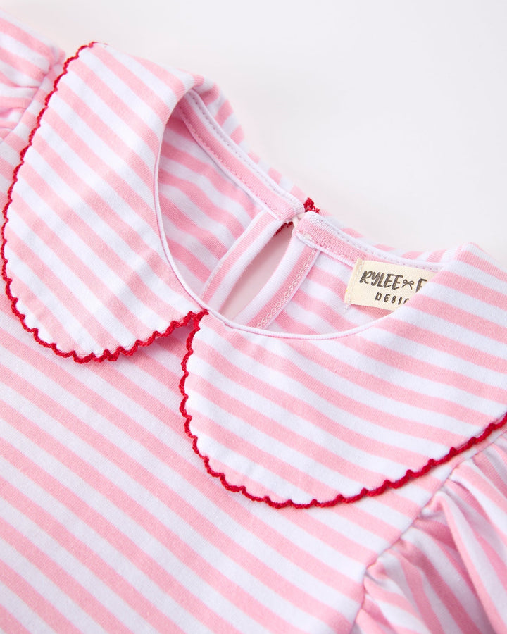 Pink and white striped dress with scalloped collar on a white background