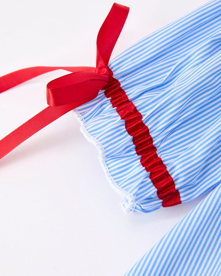 Blue and white striped fabric with a red ribbon on a white background