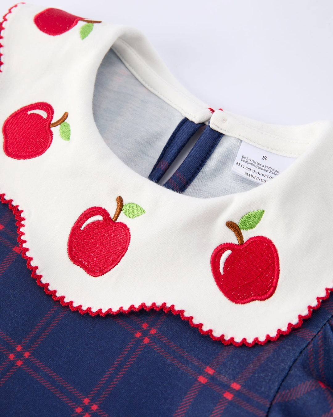 Dress with red apple designs on a blue plaid background